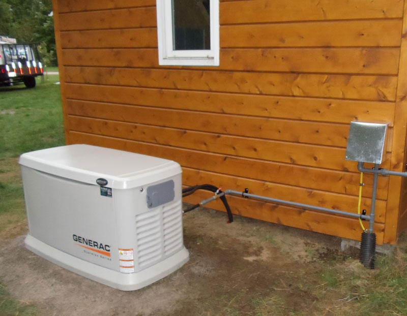 Residential generator installed outside of house.