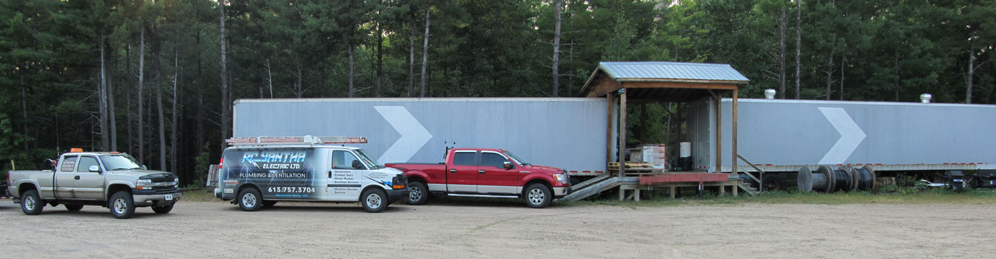 Our trucks outside the storage and equipment trailers.